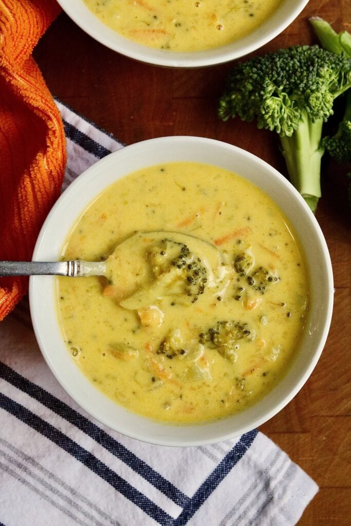 vegan broccoli cheddar soup in a bowl with a spoon