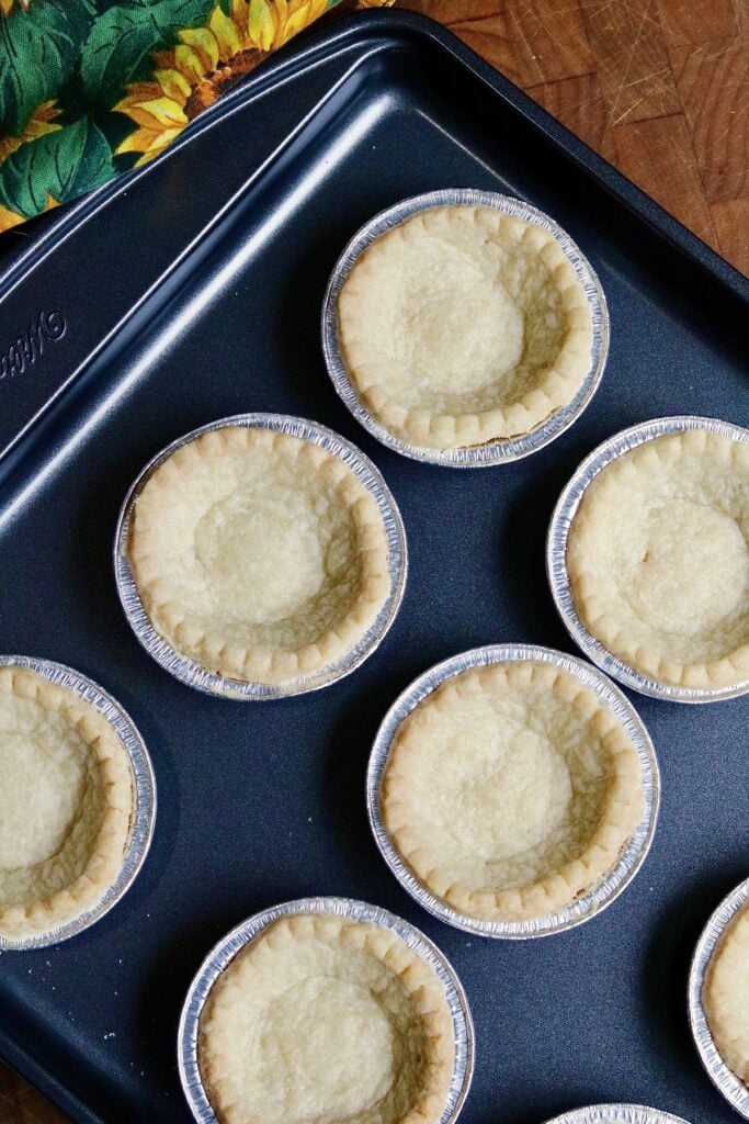 tart shells on a baking sheet