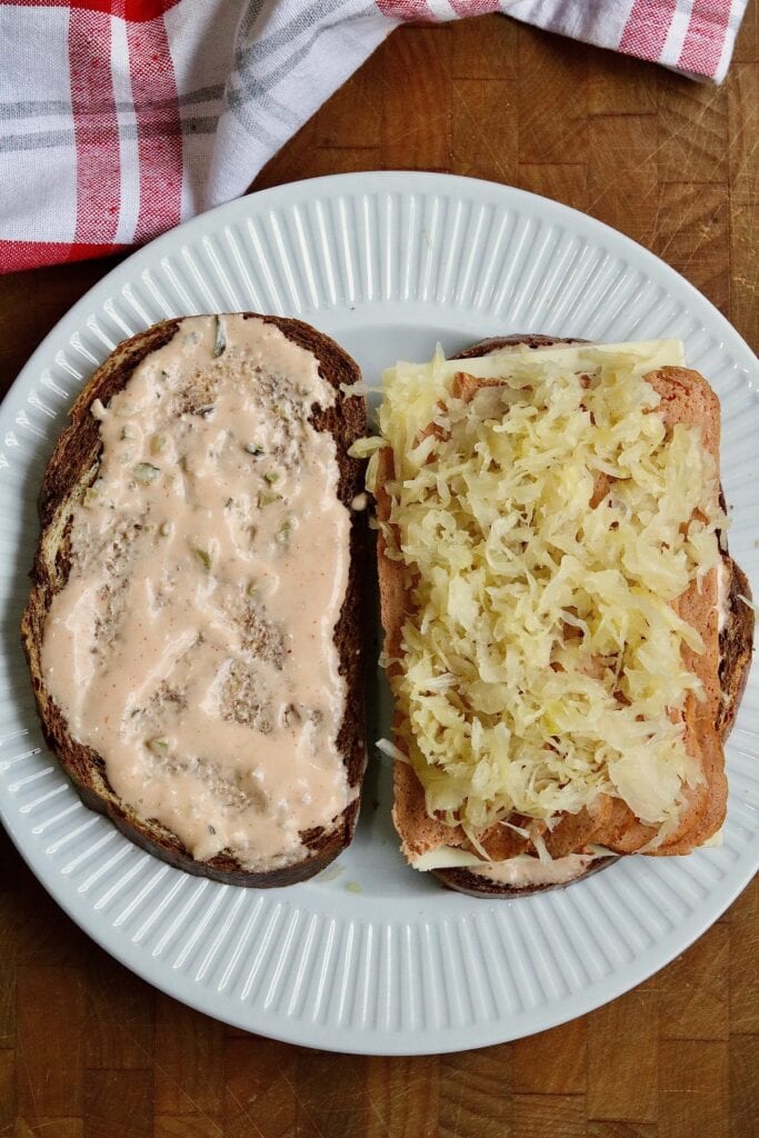 ingredients fro vegan reuben piled on rye bread