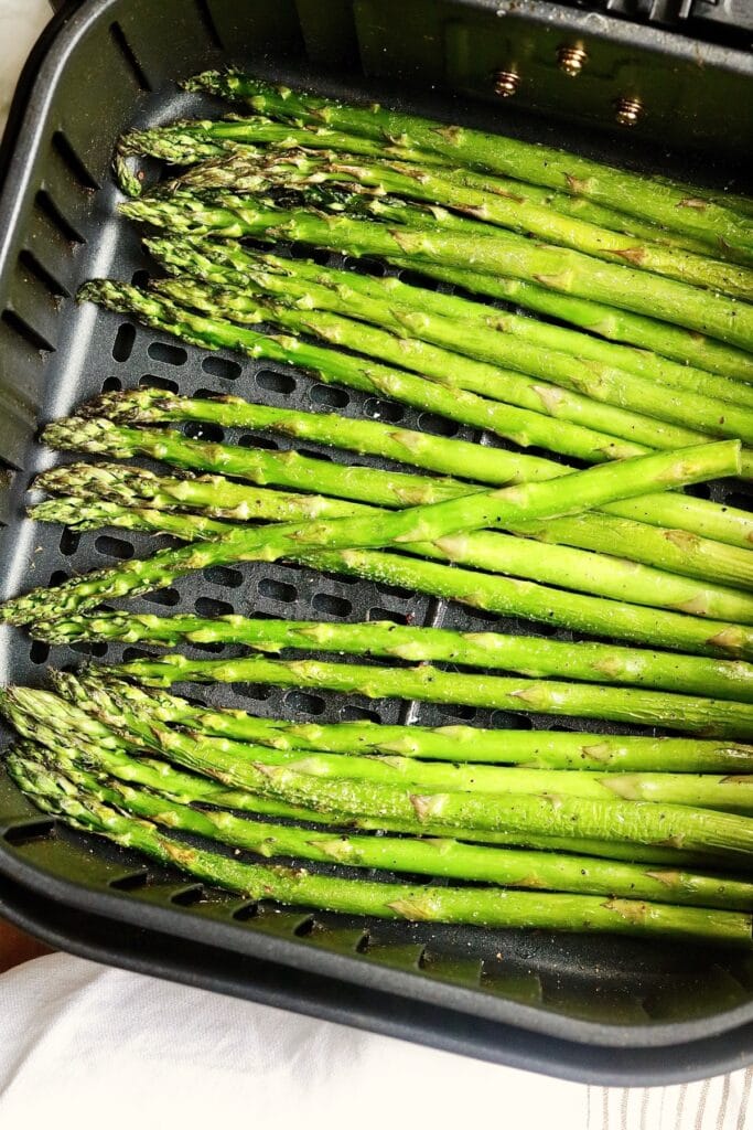asparagus spears cooked in an air fryer basket