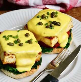vegan eggs benedict on a plate with hollandaise sauce