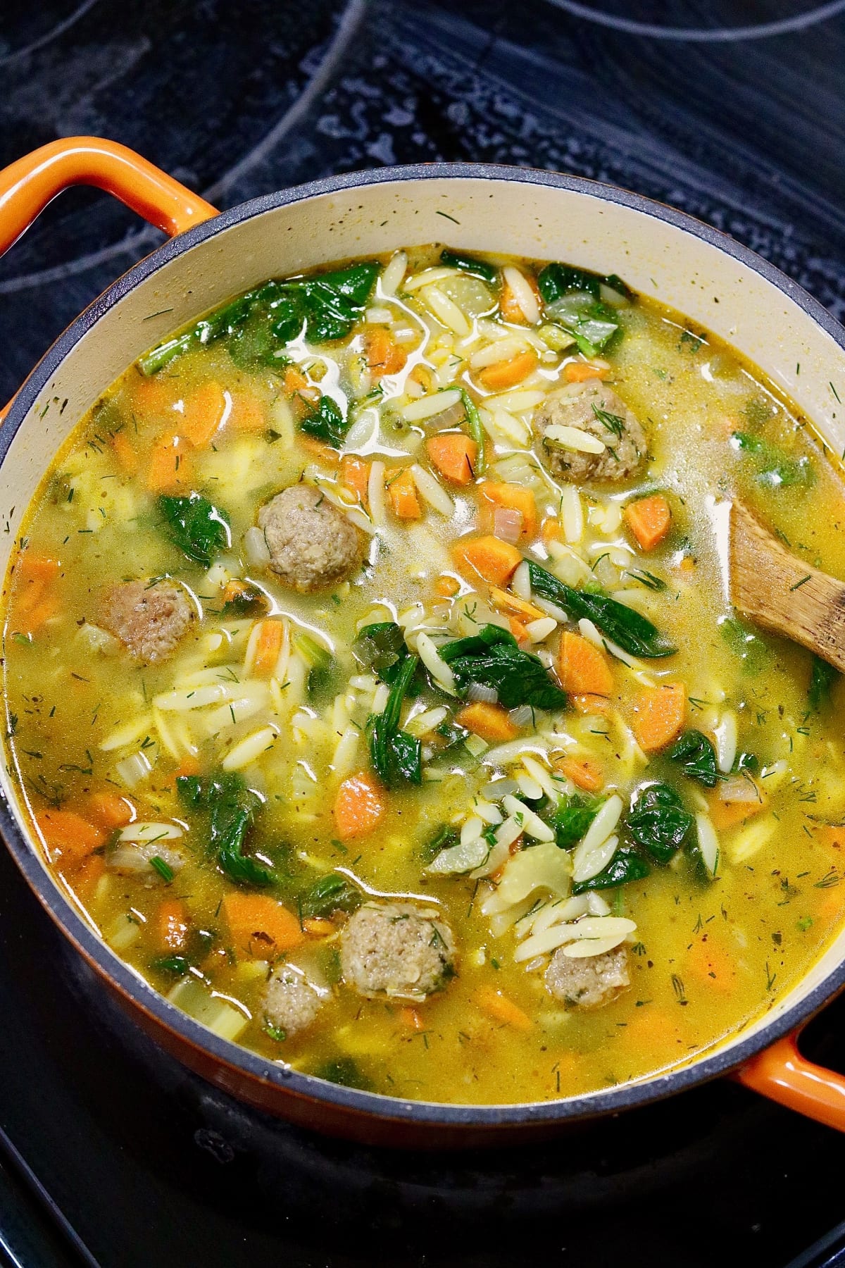 ingredients for vegan Italian meatball soup simmering in a pot