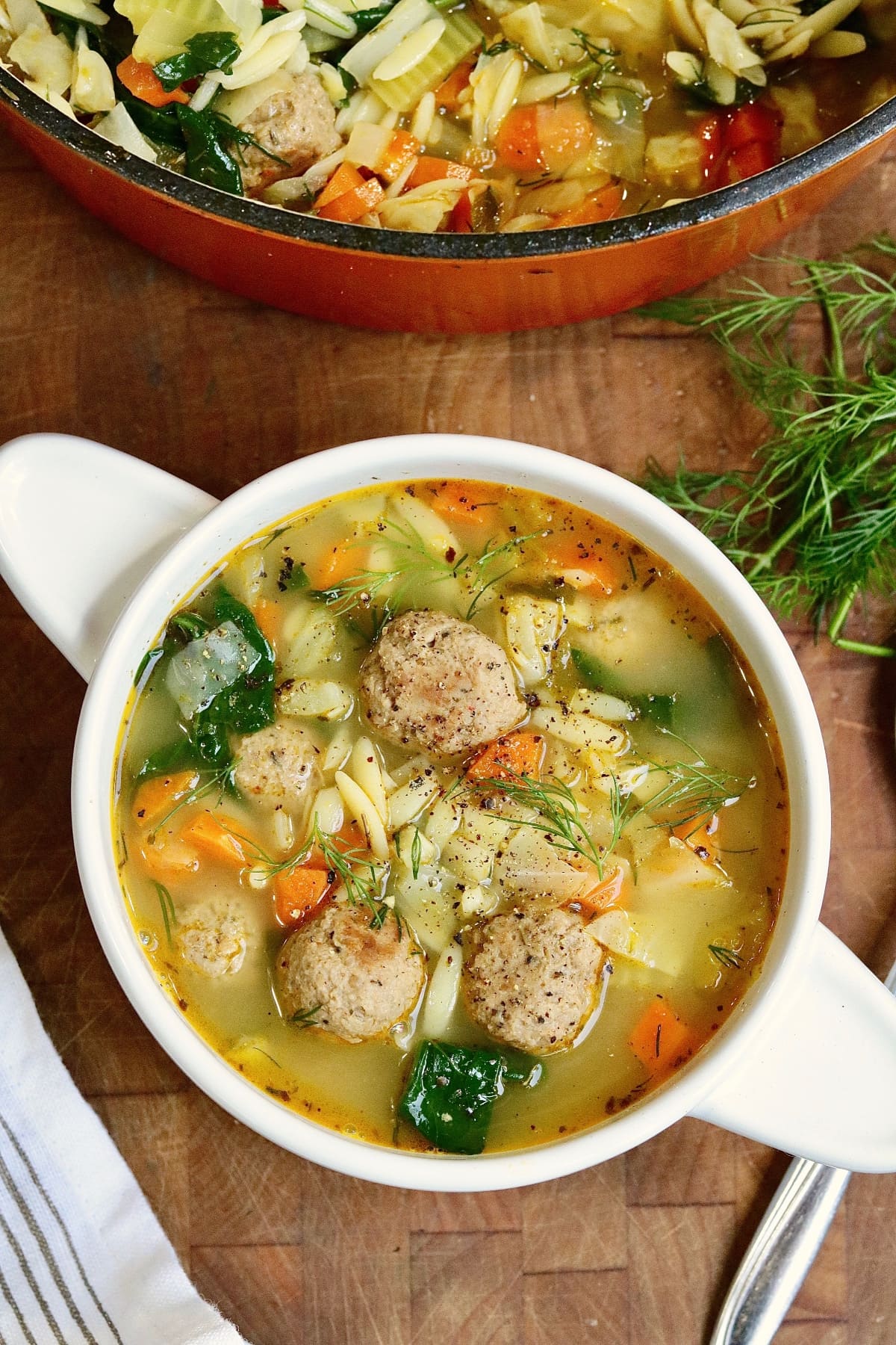 vegan Italian wedding soup in a white bowl 