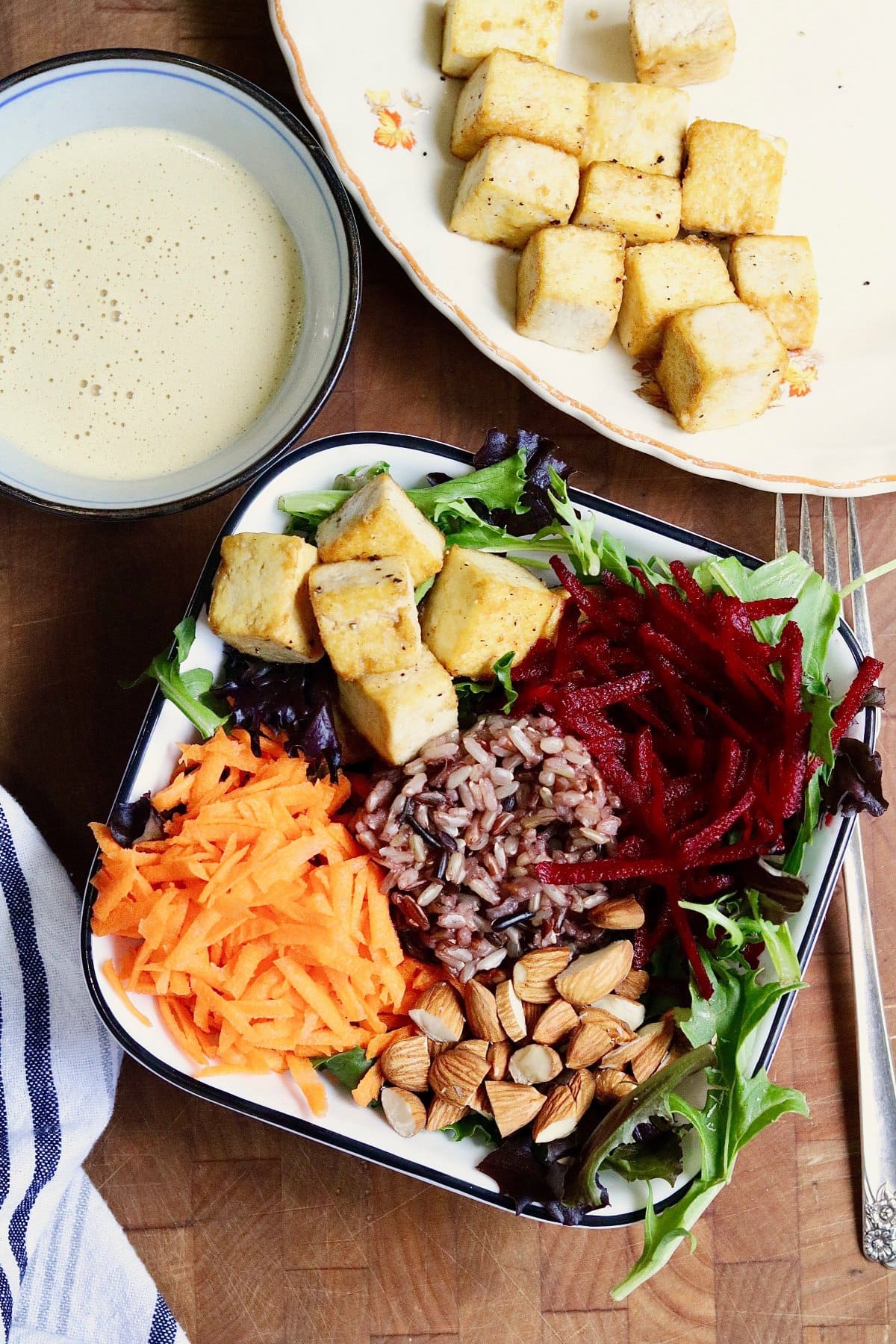 ingredients for glory bowl being assembled in a salad bowl