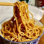 hibachi noodles in a bowl with chopsticks