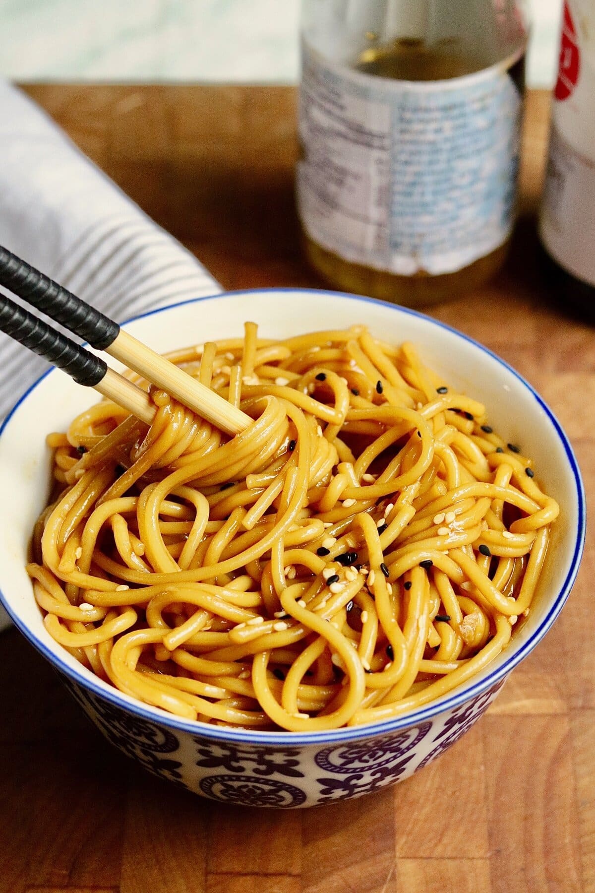 a bowl of hibachi noodles dressed with sauce ready to serve