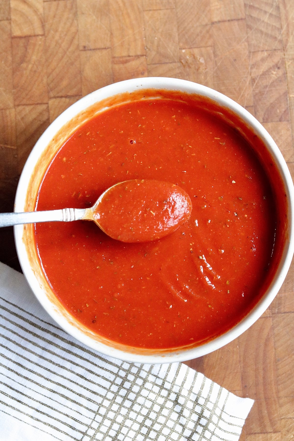 pizza sauce mixed in a bowl with a spoon