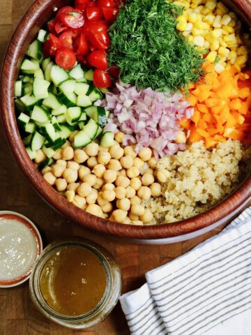 ingredients for quinoa salad with chickpeas in a bowl ready to be mixed with dressing