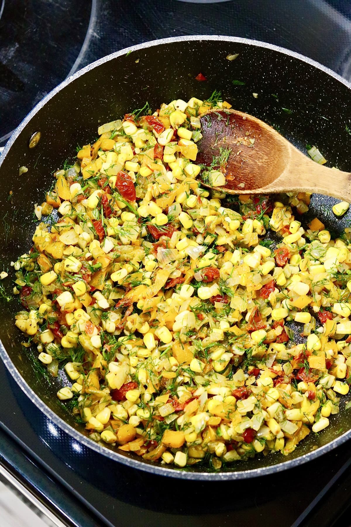 filling ingredients for vegan egg muffins in a frying pan