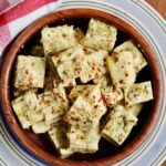 cubes of greek marinated tofu in a bowl for vegan feta cheese