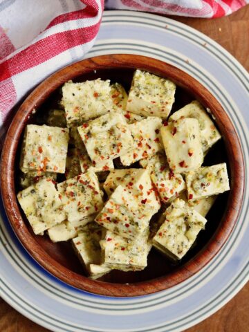 cubes of greek marinated tofu in a bowl for vegan feta cheese