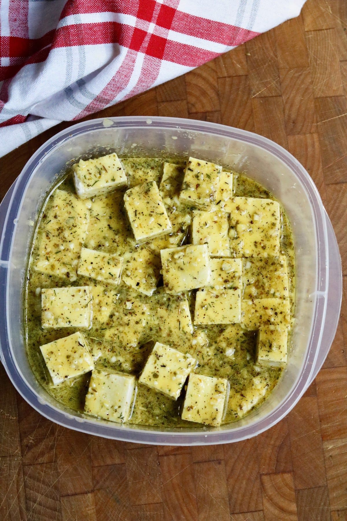 cubes of tofu marinating in brine for vegan feta cheese