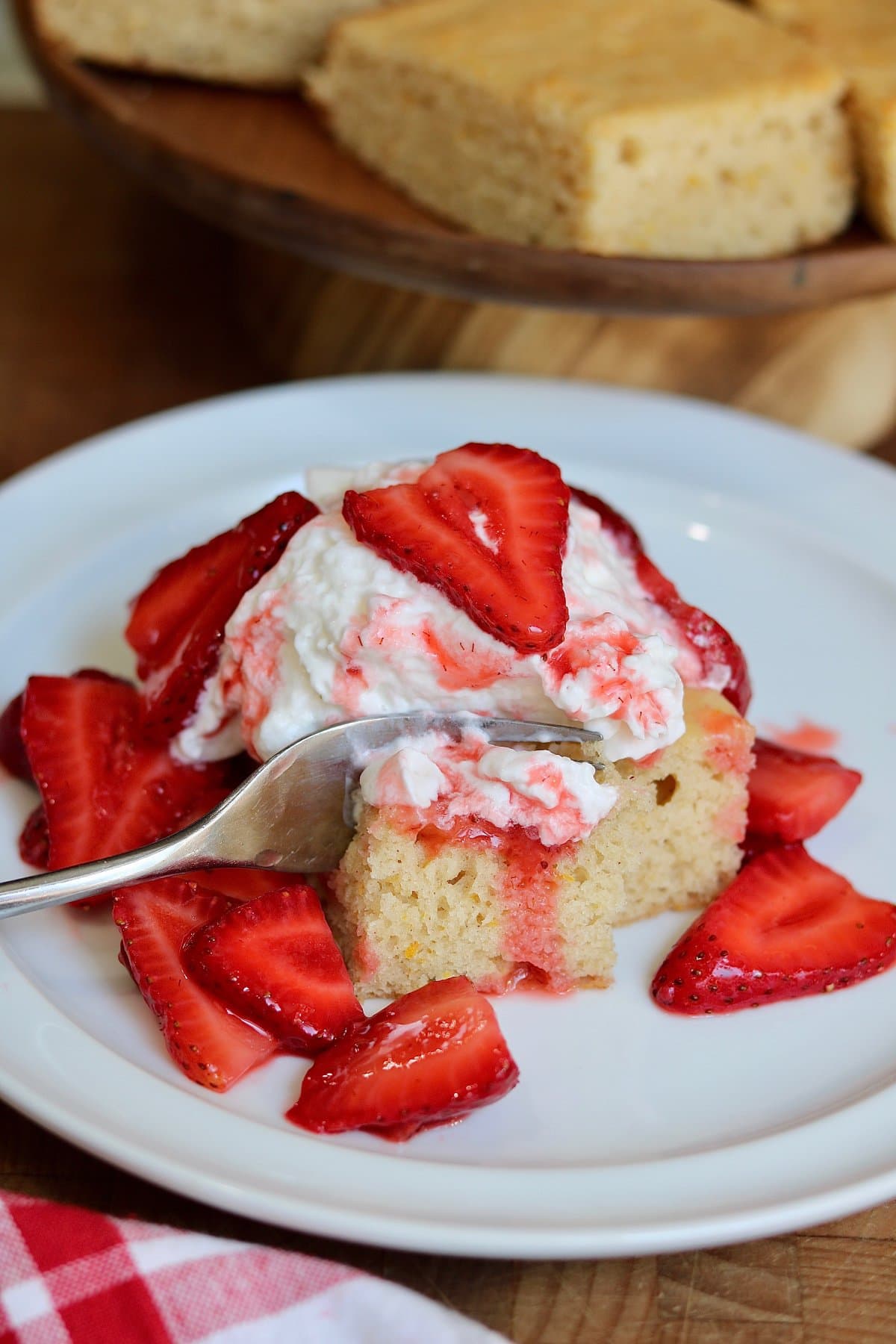 vegan strawberry shortcake on a plate with a fork