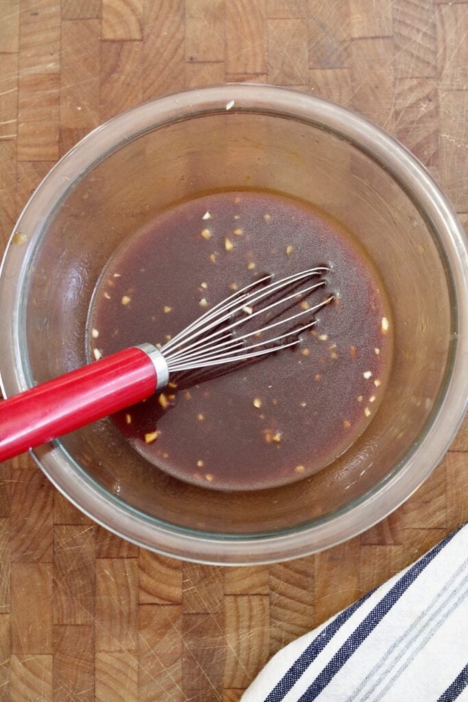 ingredients for bbq tofu marinade in a bowl with a whisk