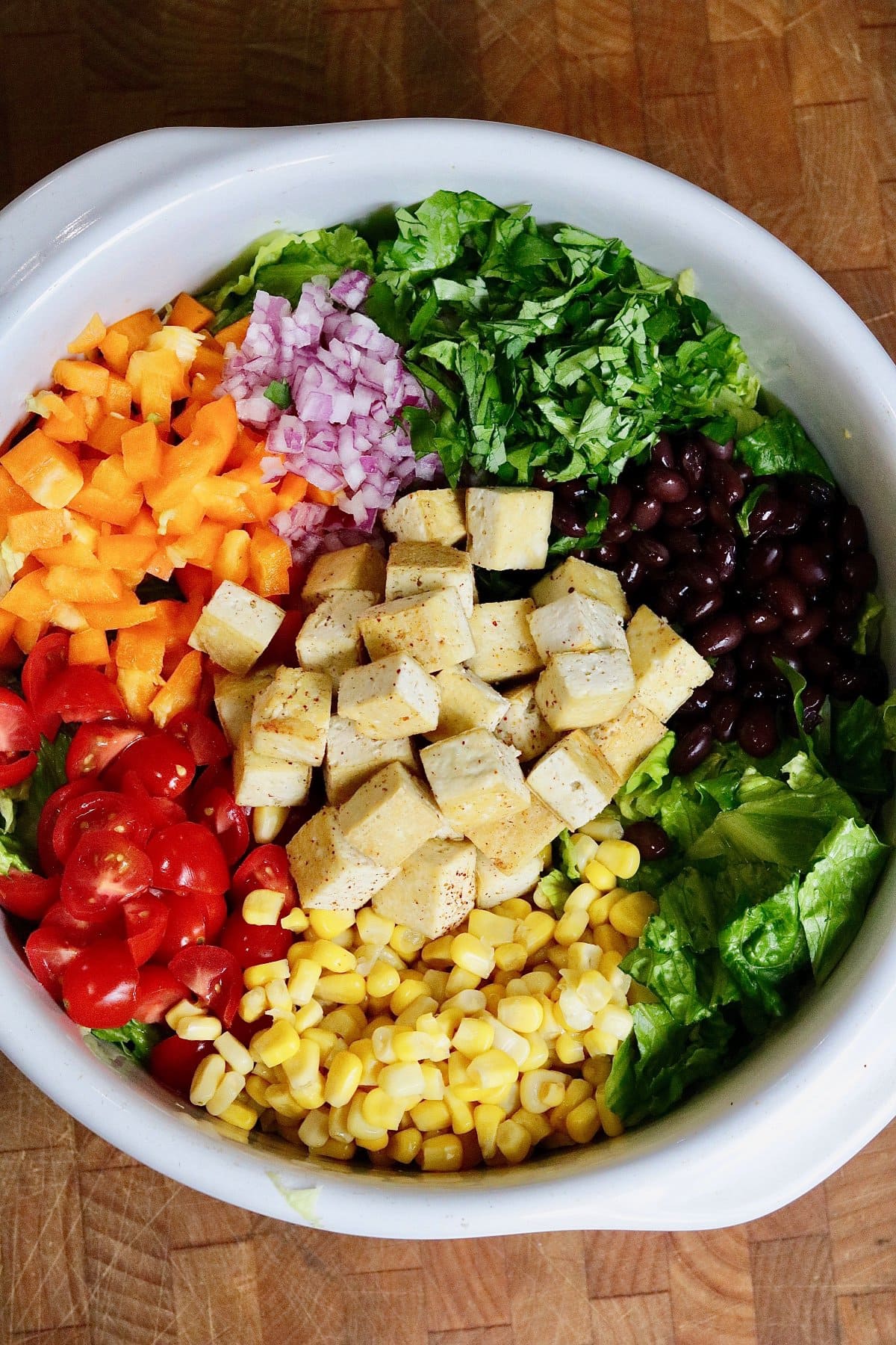 Ingredients for Mexican chopped salad prepped in a large bowl