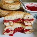 strawberry rhubarb jam slathered on a bagel with peanut butter
