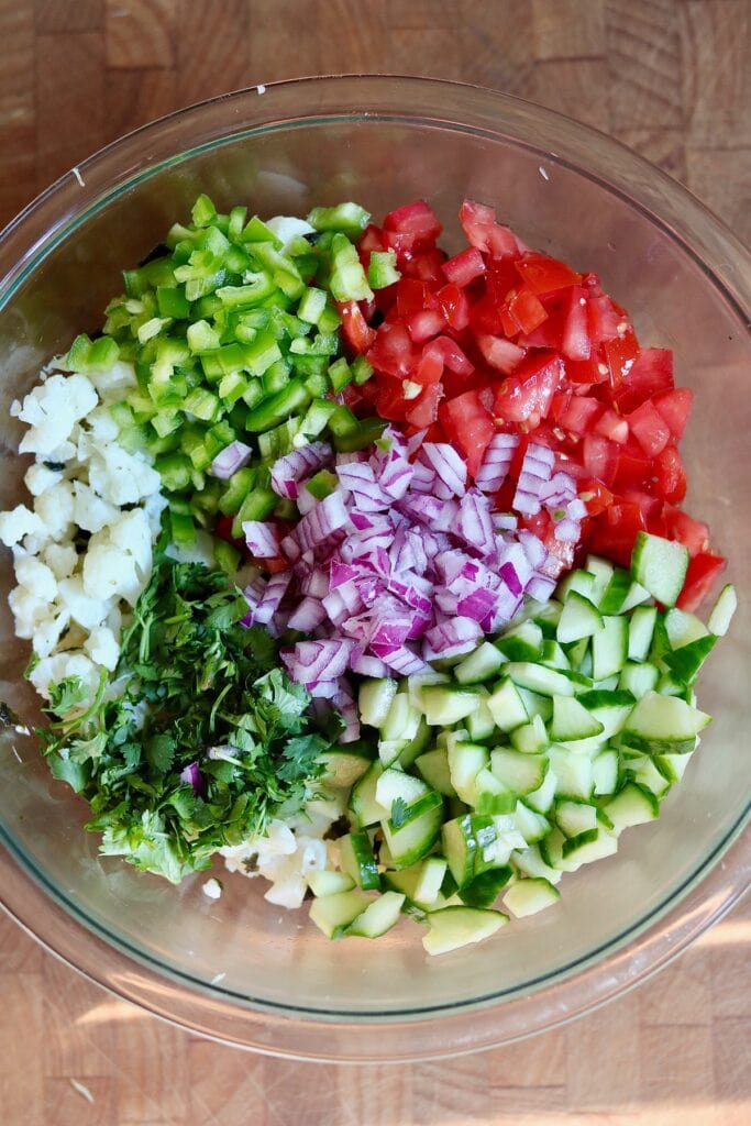 cauliflower and veggies chopped in a bowl for vegan ceviche