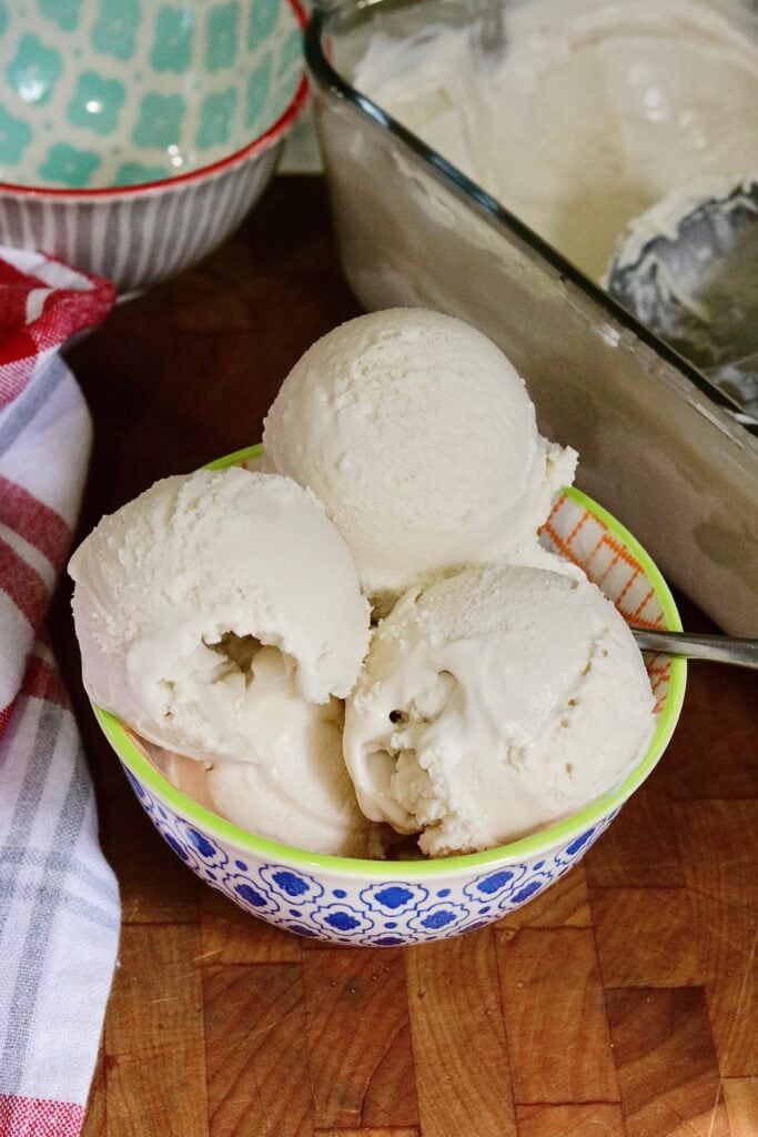 three scoops of vegan vanilla ice cream in a bowl