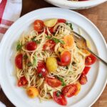 cherry tomato pasta with hot spaghetti on plate with a fork