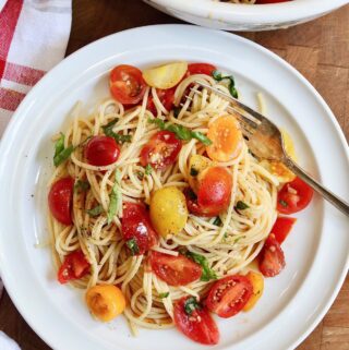 cherry tomato pasta with hot spaghetti on plate with a fork