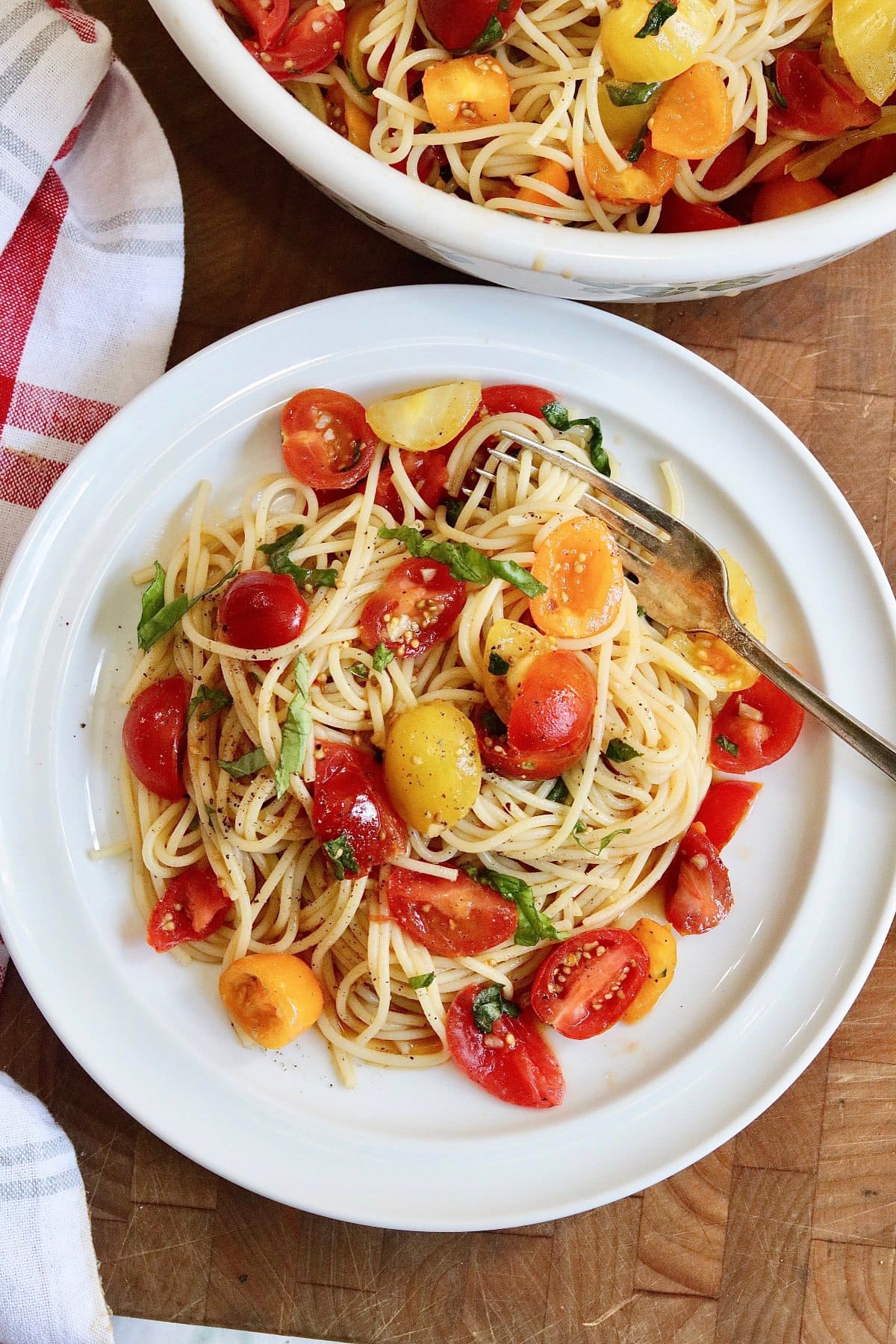 cherry tomato pasta with hot spaghetti on plate with a fork