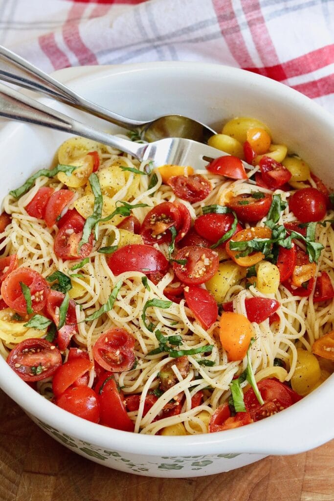 cherry tomato spaghetti pasta in a serving bowl hot and ready to serve