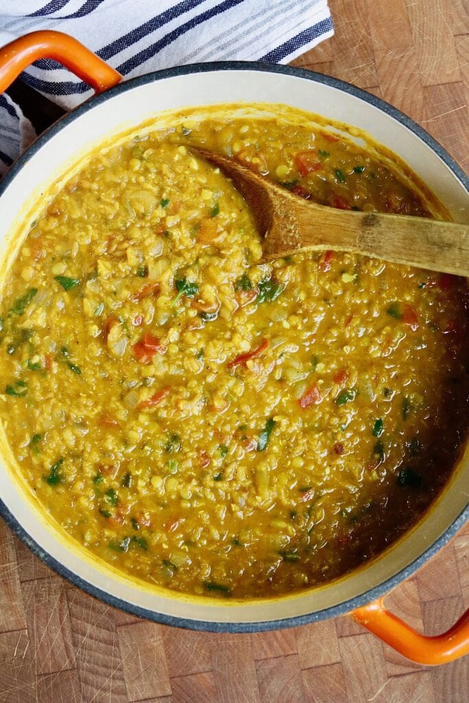 a pot of red lentil dahl ready to serve