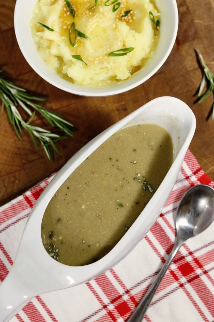 a gravy boat of miso gravy with mashed potatoes