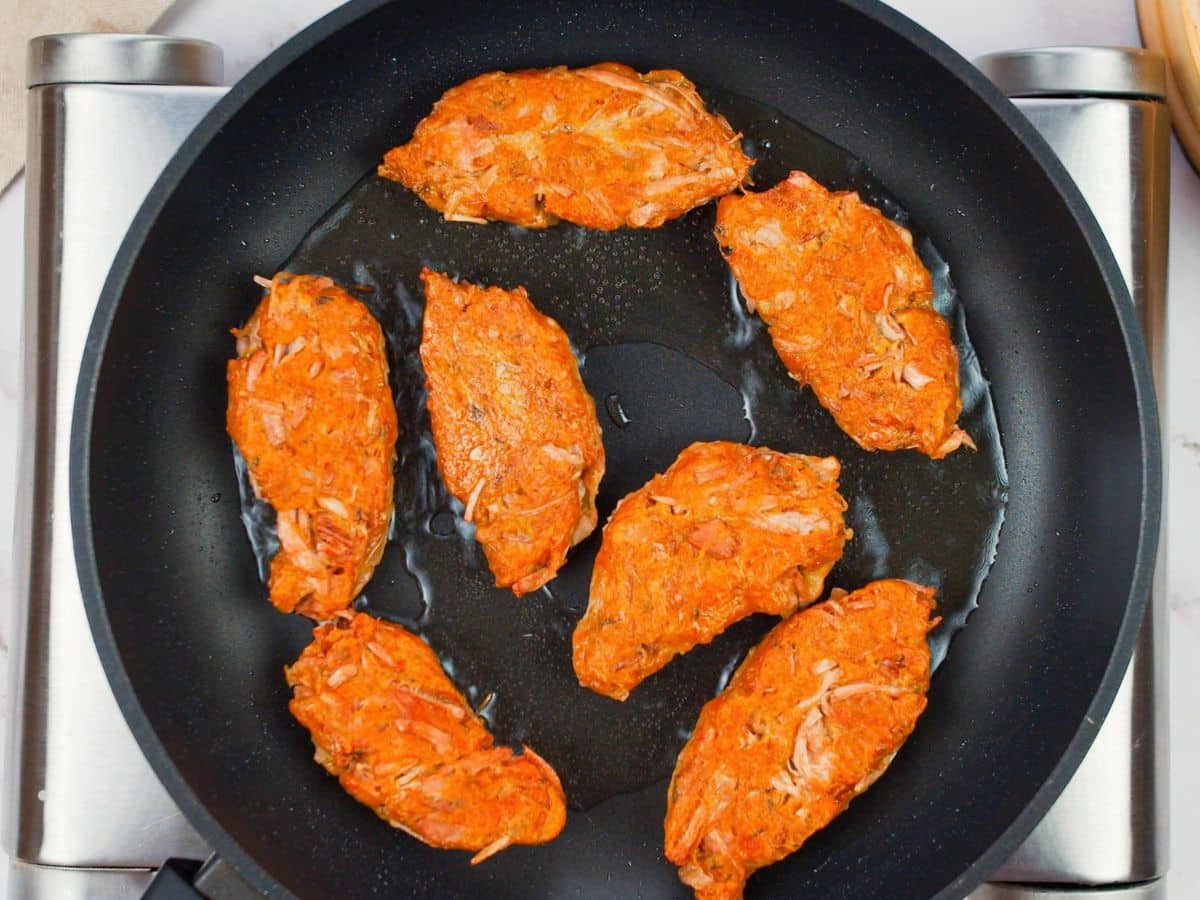 vegan wings in skillet on hot plate