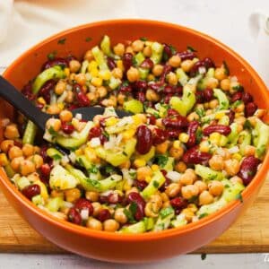 white bowl with red trim filled with vegan kidney bean salad