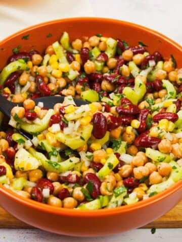 white bowl with red trim filled with vegan kidney bean salad