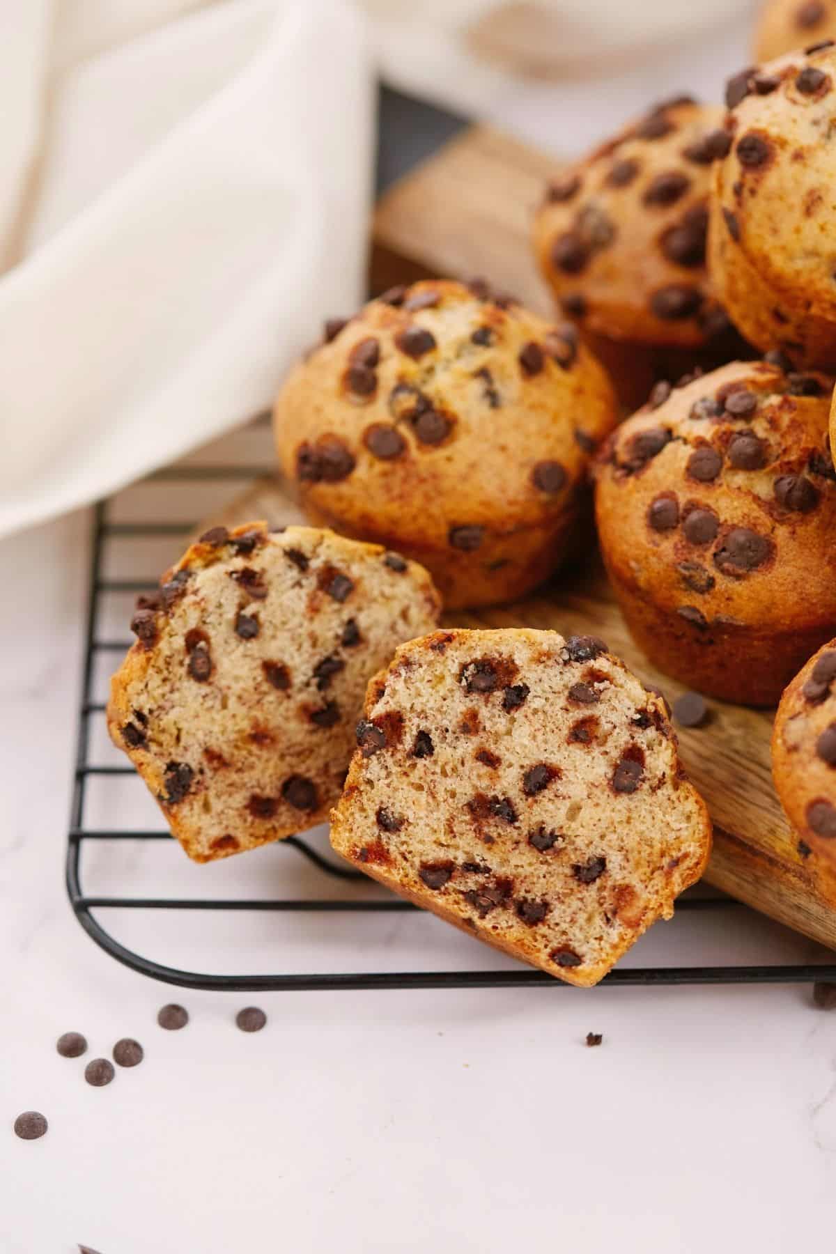vegan chocolate chip muffins stacked on black wire rack on white table