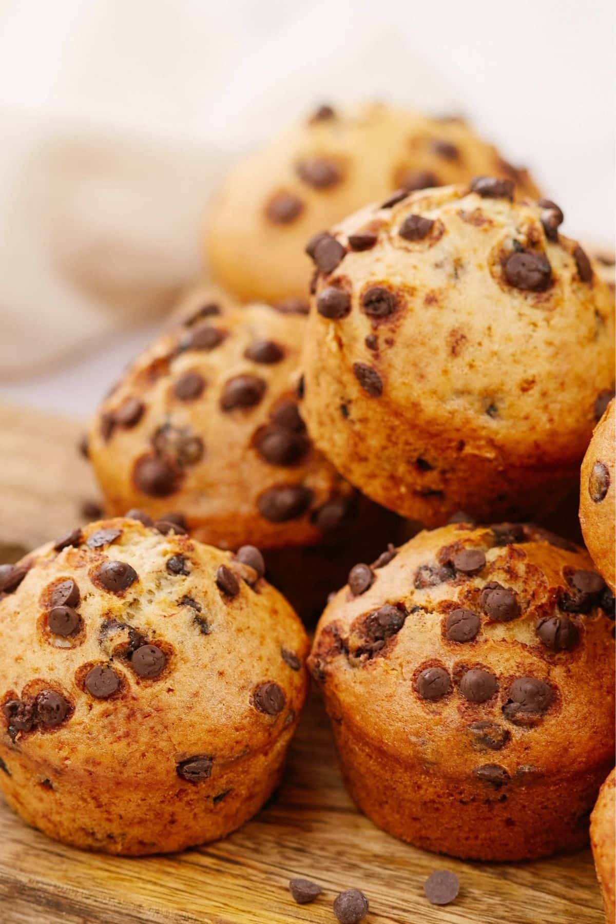 chocolate chip muffins stacked on plate
