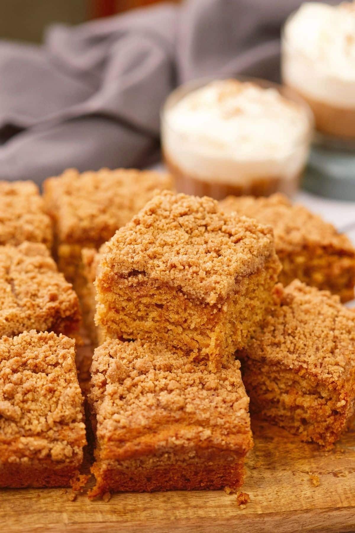 stacked coffee cake slices on wooden cutting board 