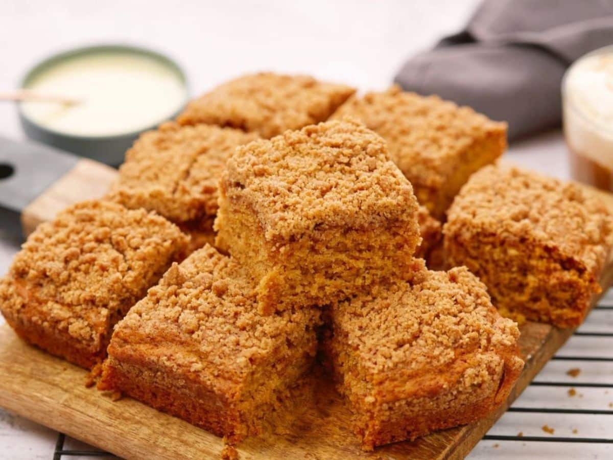 vegan coffee cake on wooden cutting board on top of wire rack