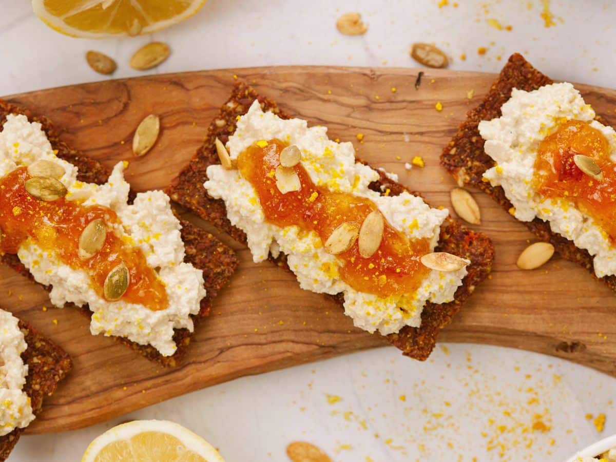 toast on board with pumpkin seeds, cottage cheese, and jam