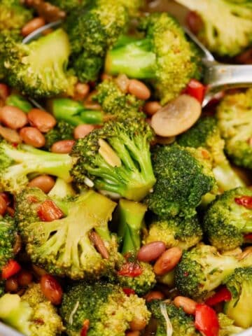round bowl of broccoli stir fry on wood table