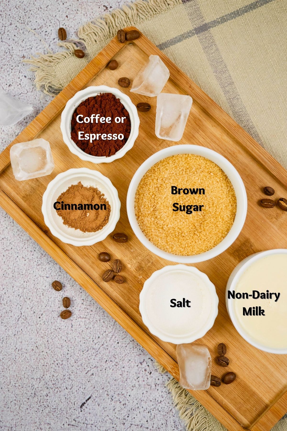 round ramekins of ingredients for shaken espresso sitting on wooden platter
