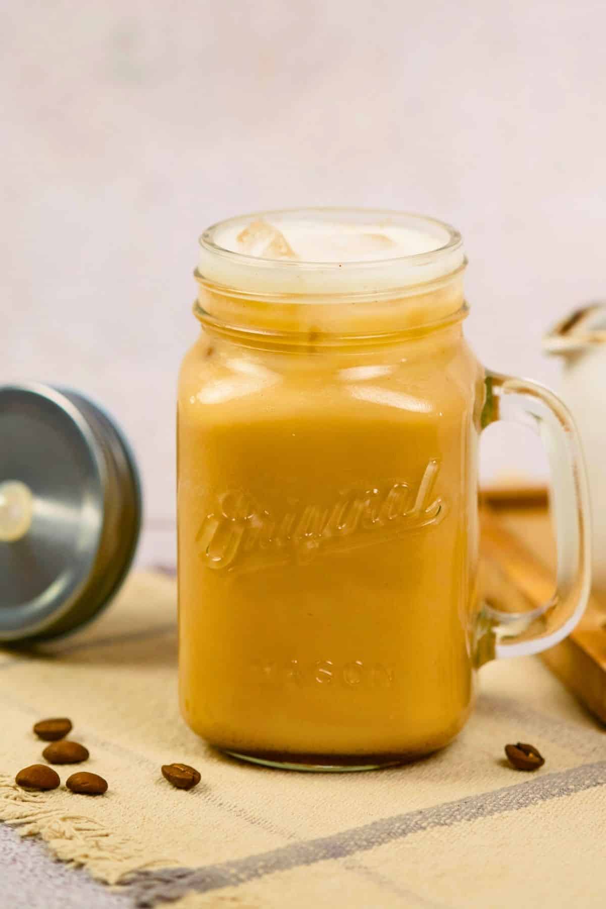 mug of coffee drink on table by lid with straw