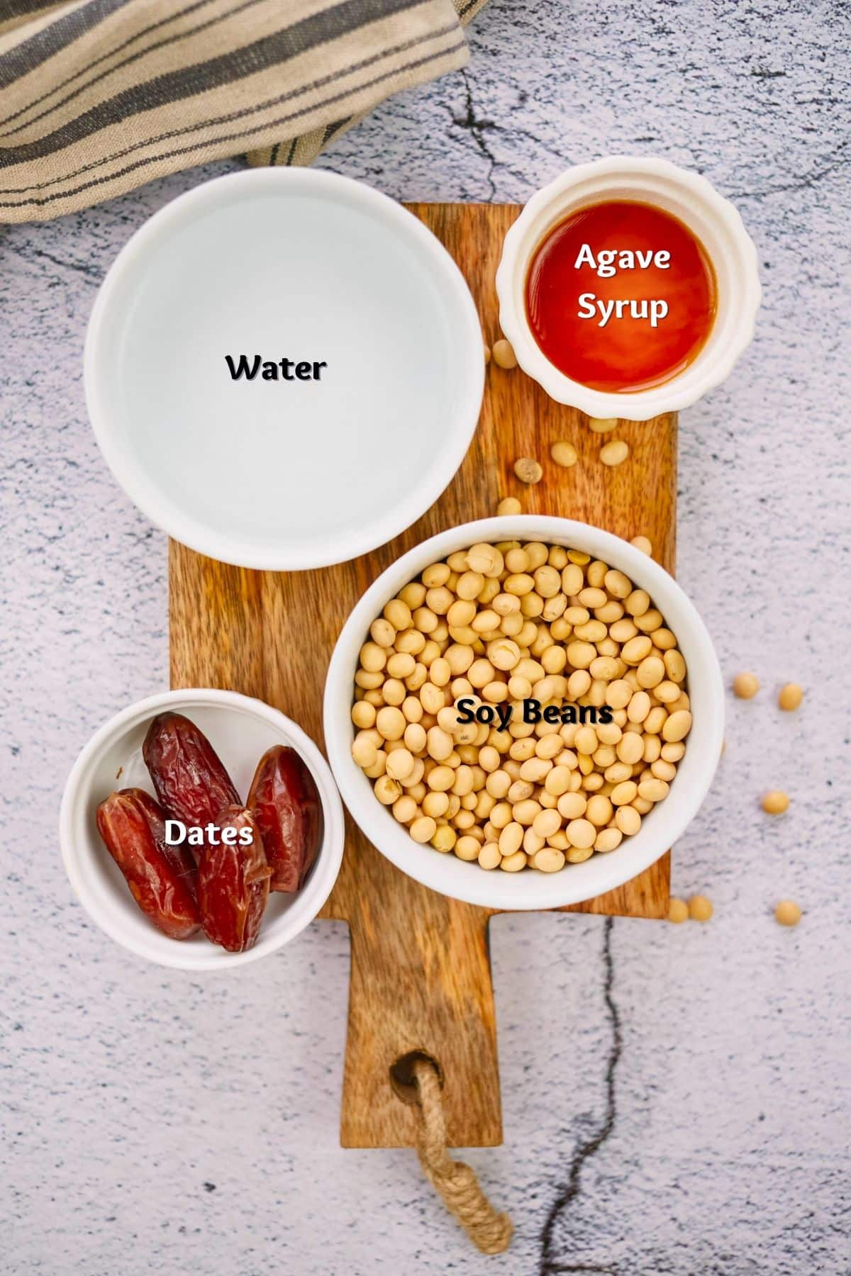 ingredients for homemade soy milk in ramekins on cutting board