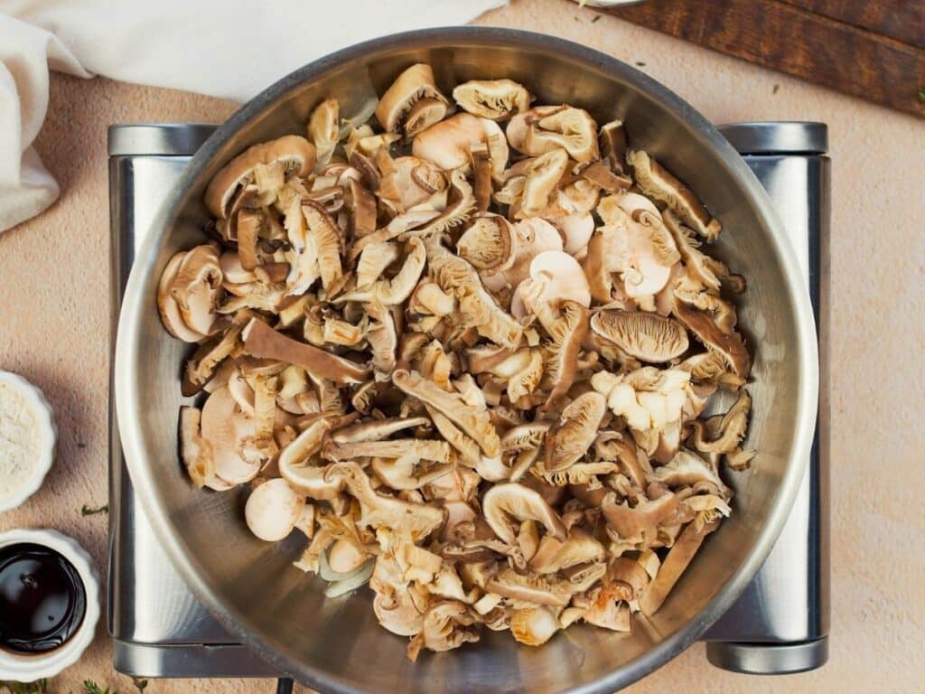 mushrooms in skillet on top of hot plate