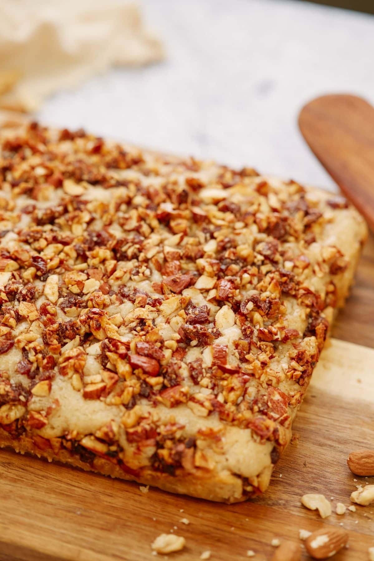 vegan baklava cake on two toned wooden cutting board