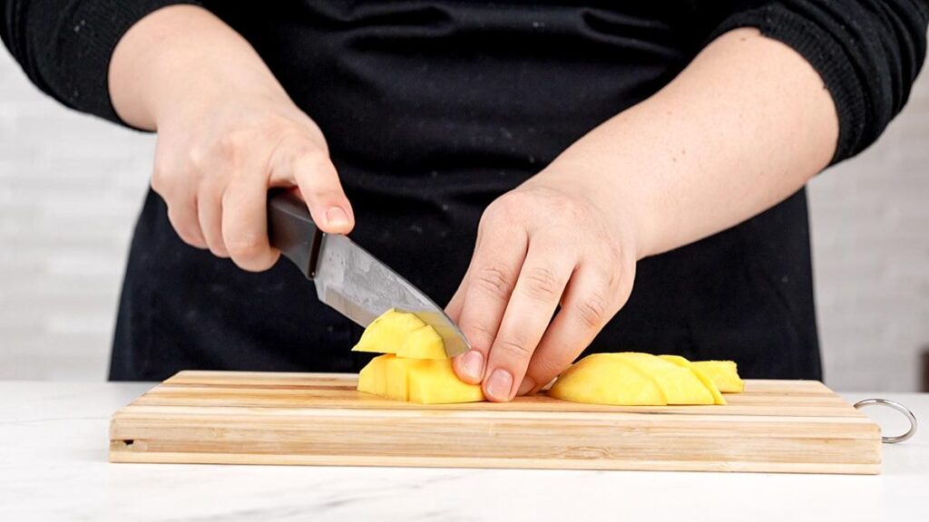 mango being diced on cutting board