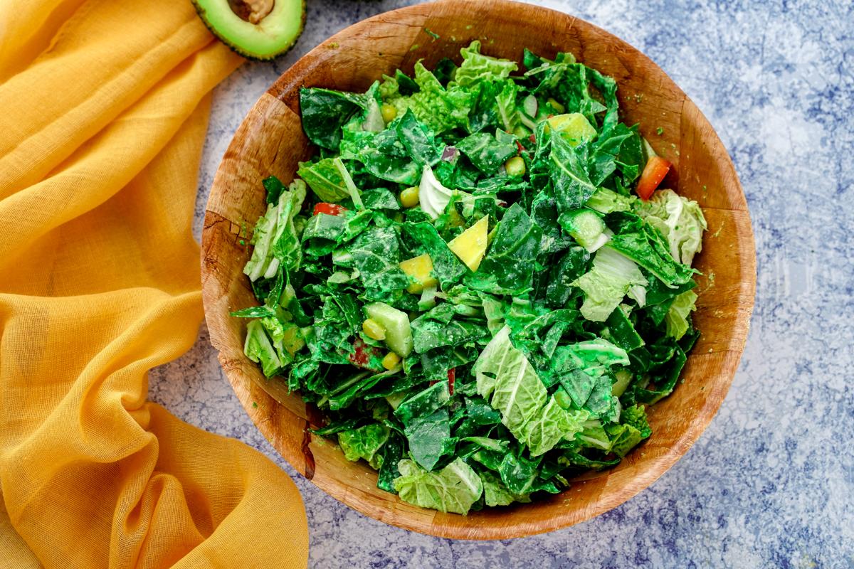 wood bowl filled with avocado mango salad