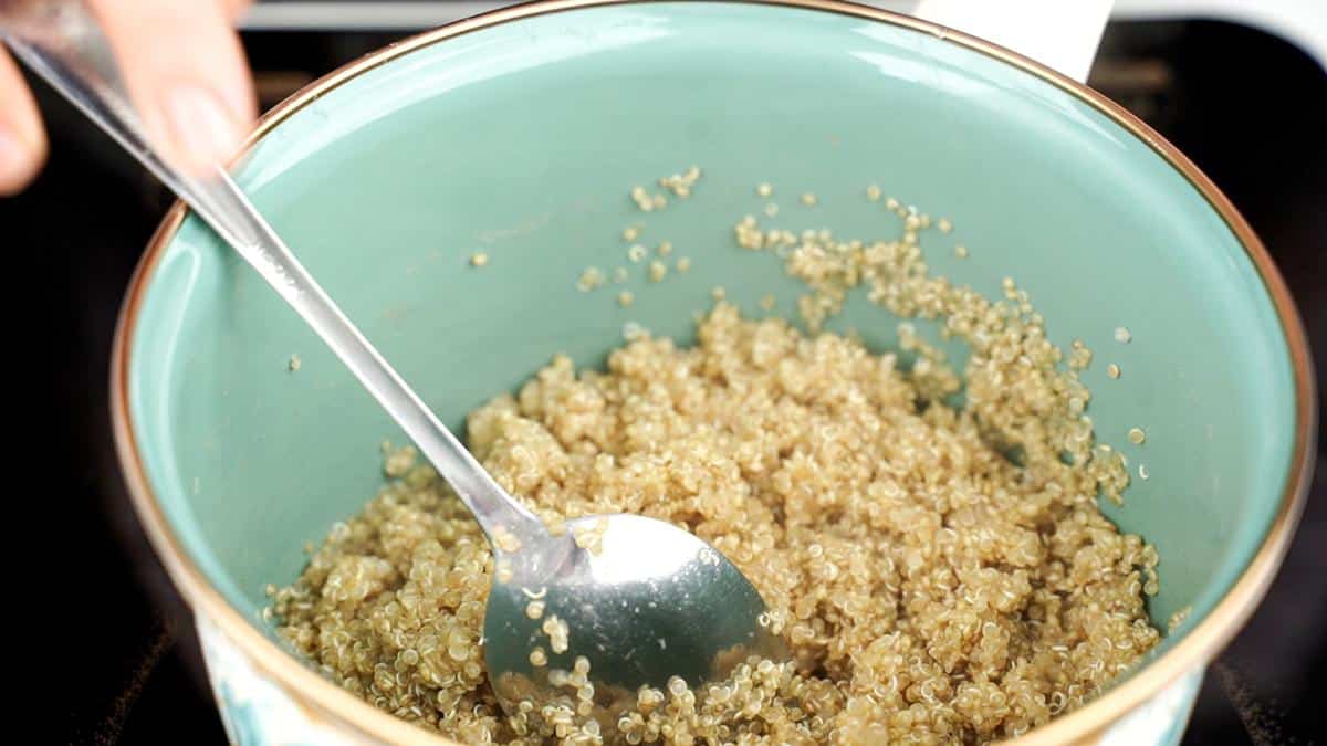 spoon in blue saucepan of quinoa