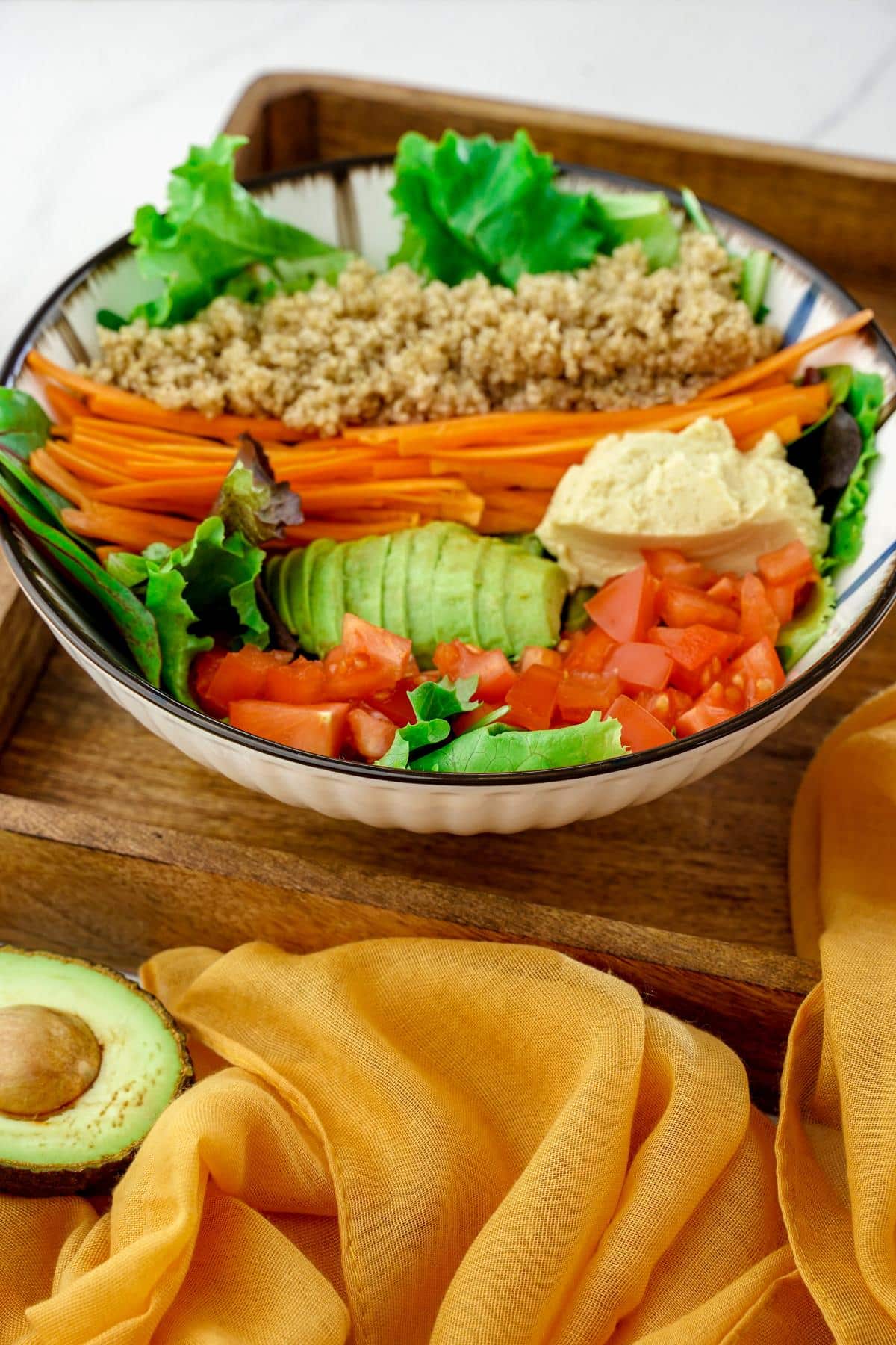 bowl of salad on wood tray