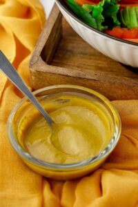 yellow salad dressing in glass bowl
