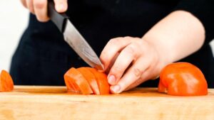 knife slicing tomato