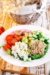 farro summer salad in white bowl on rustic table
