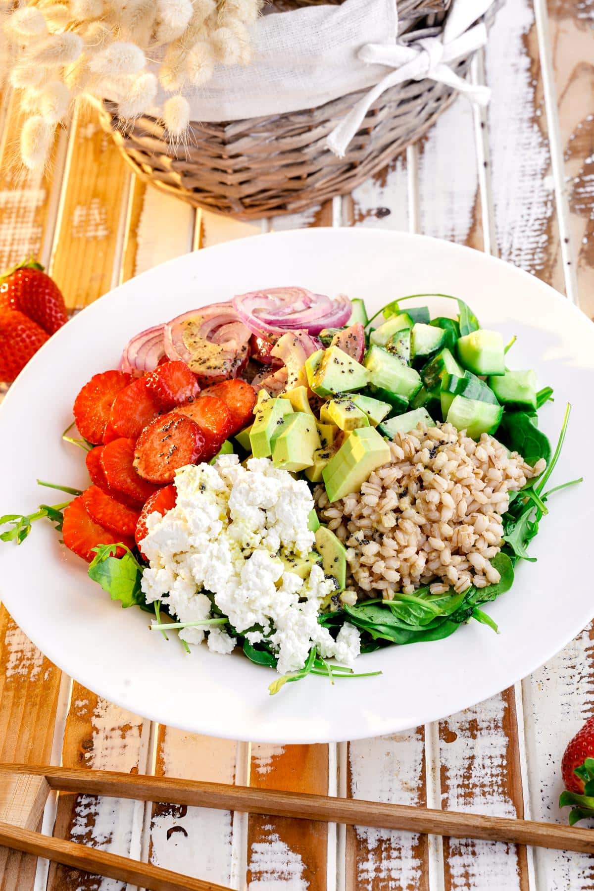 white bowl of farro summer salad on rustic wood table